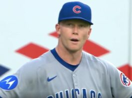 Cubs Outfielder Pete Crow-Armstrong checking the scoreboard to see why there are only 2 outs